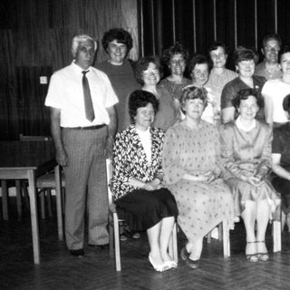 Group of people posing indoors, likely at an event.