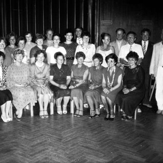 Group of people posing indoors, likely at an event.