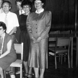 Group of people posing indoors, likely at an event or gathering.