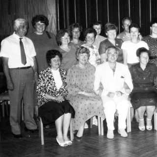 Group of people posing indoors, likely at an event or gathering.