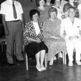 Group of people posing indoors, likely at an event or gathering.