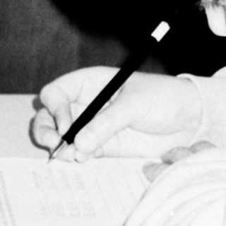 A young girl drawing with a ruler.