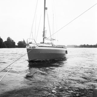 Sailboat anchored in calm water.