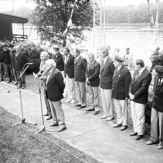 Formal outdoor ceremony with dignitaries and speeches.