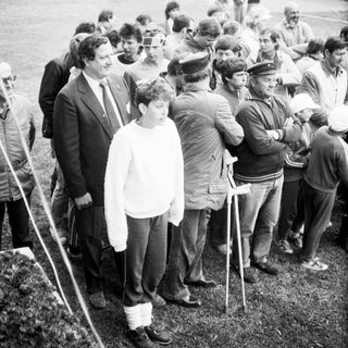 People waiting in line outdoors during what appears to be a public event or gathering.