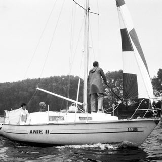 Classic sailboat named "Anie II" on water.