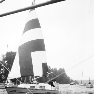 Classic sailboat named "Anie II" sailing on water.