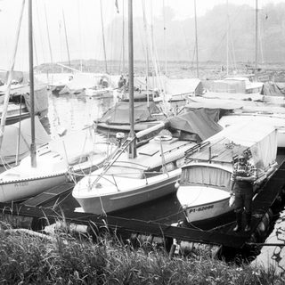 Marina with moored sailboats and yachts.