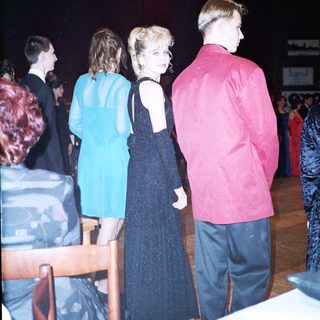 Prom or formal dance event attendees in evening attire.