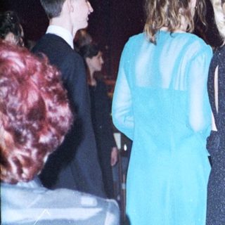 Prom or formal dance event attendees in evening attire.