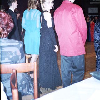 Prom or formal dance event attendees in evening attire.