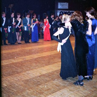 Prom or formal dance event with students in evening attire.