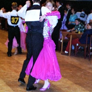 Ballroom dancers performing in a social dance event.