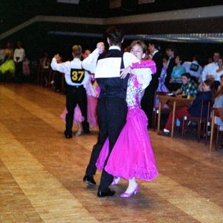 Ballroom dancers performing in a social dance event.