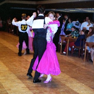 Ballroom dancers performing in a social dance event.