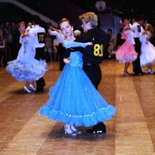 Children dancing in a ballroom competition.