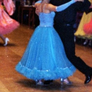 Ballroom dance performance with traditional attire.