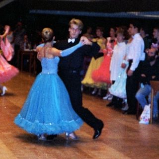Ballroom dance performance with traditional attire.