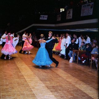 Ballroom dance performance with traditional attire.