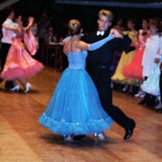 Ballroom dance performance with traditional attire.