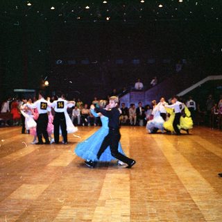 Ballroom dance competition with couples performing.