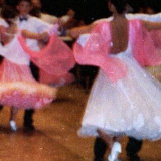 Ballroom dance competition with couples performing.