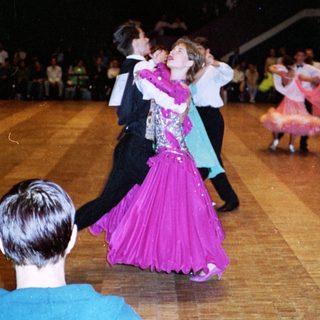 Ballroom dance competition with couples performing.