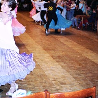 Ballroom dance competition with participants performing.