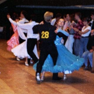 Ballroom dance competition with participants performing.