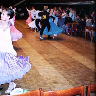 Ballroom dance competition with participants performing.