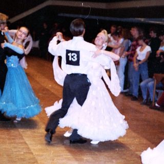 Ballroom dance competition with couples performing.