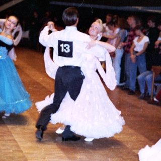 Ballroom dance competition with couples performing.