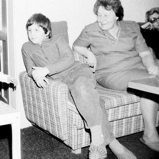 Family moment indoors with children and elderly woman.