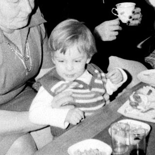 Family gathering enjoying meal together indoors.