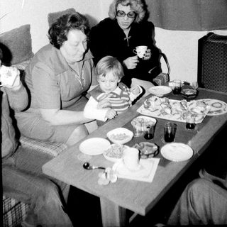 Family gathering enjoying meal together indoors.