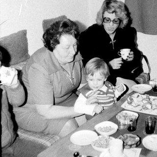 Family gathering enjoying meal together indoors.