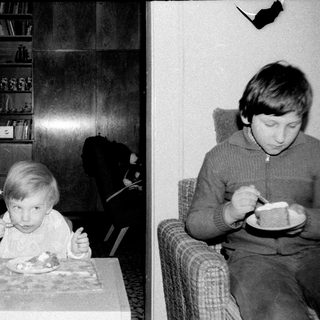 Two children eating indoors during a meal.