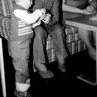 Family members playing card game indoors.
