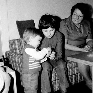 Family members playing card game indoors.