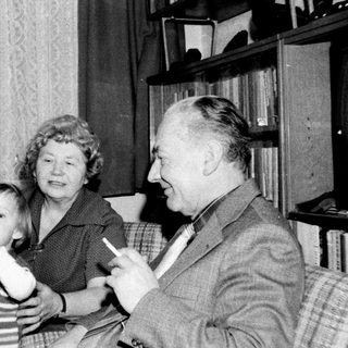 Family enjoying indoor game together in vintage living room.