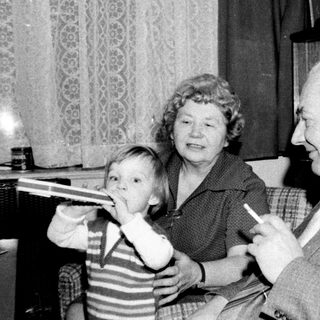 Family enjoying indoor game together in vintage living room.
