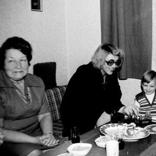 Family gathering around a meal indoors.