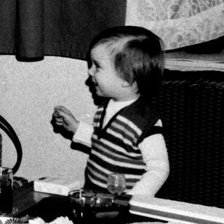 Family meal scene with two adults and a young child.
