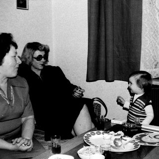 Family meal scene with two adults and a young child.