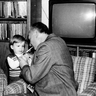 Family sharing a moment indoors with old television.