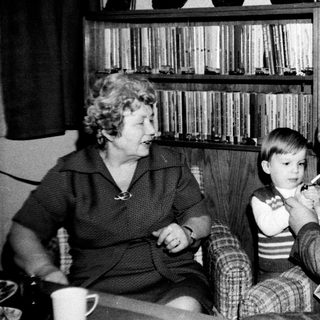 Family sharing a moment indoors with old television.