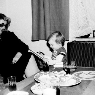 A woman and child sharing a meal indoors.