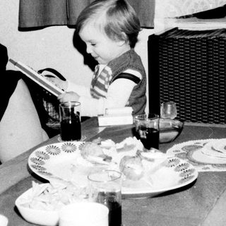 A woman and child sharing a meal indoors.