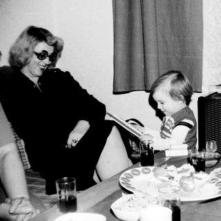 A woman and child sharing a meal indoors.