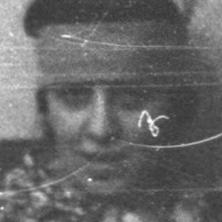 Vintage photo of elderly person in patterned clothing.